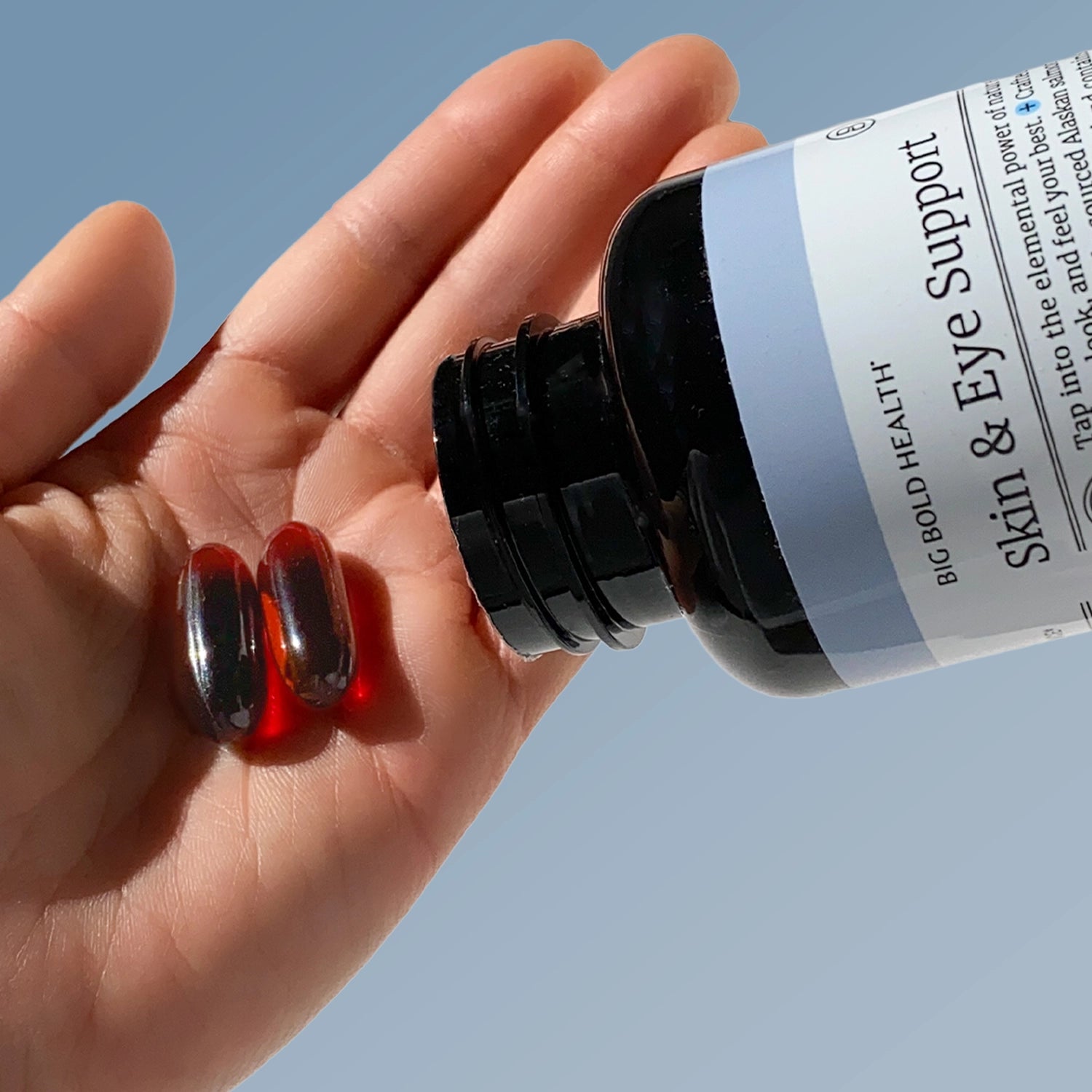 HTB Rejuvenate supplement bottle with capsules and wooden backdrop.