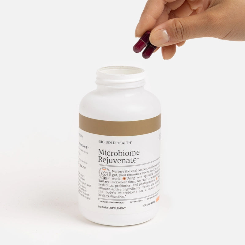 HTB Rejuvenate supplement bottle with capsules and wooden backdrop.
